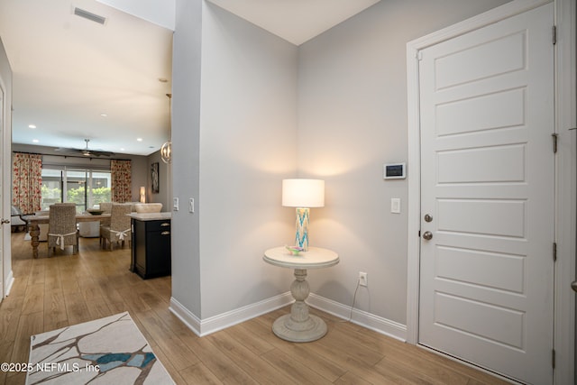 foyer entrance featuring ceiling fan and light wood-type flooring