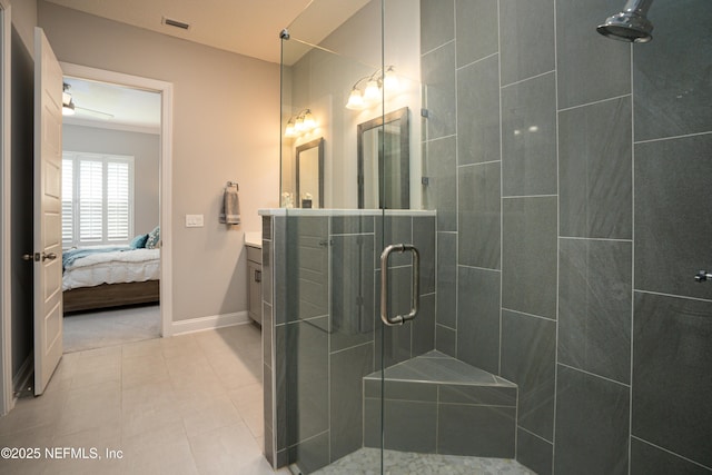 bathroom featuring tile patterned flooring, vanity, and a shower with shower door