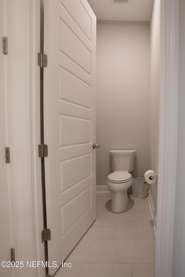 bathroom featuring tile patterned flooring and toilet