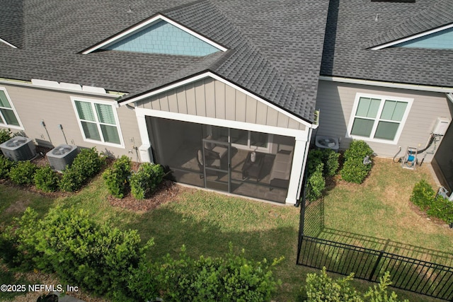 exterior space featuring central AC unit and a lawn