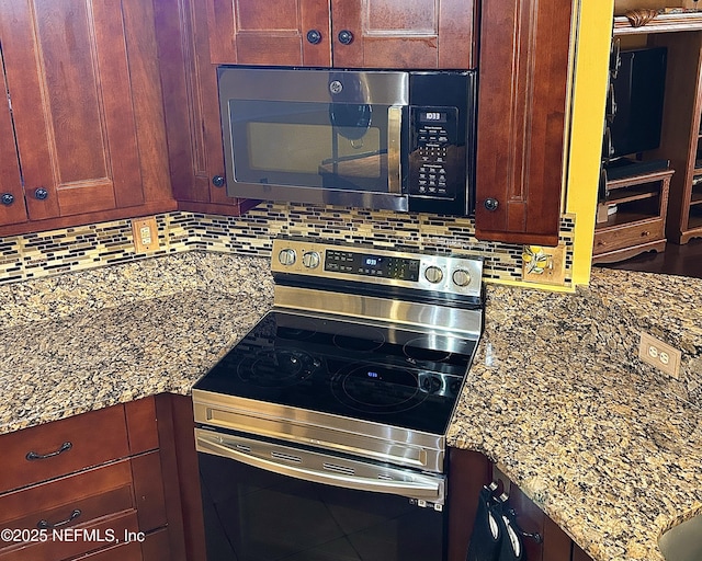 room details with stainless steel appliances, tasteful backsplash, and light stone countertops