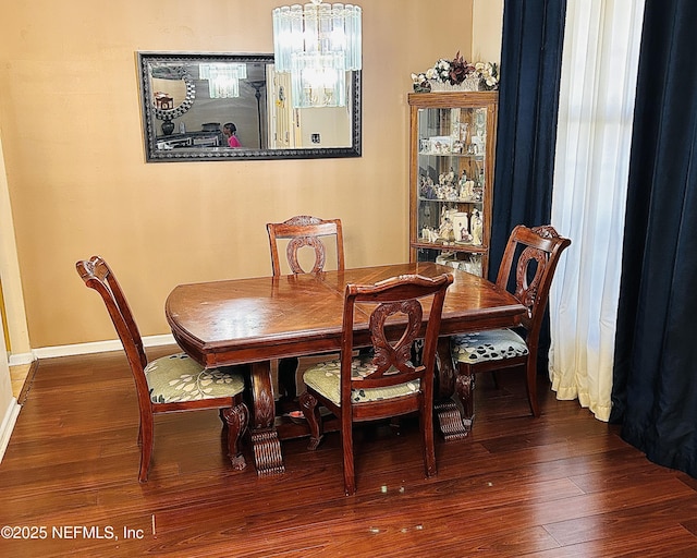 dining space with an inviting chandelier and hardwood / wood-style flooring