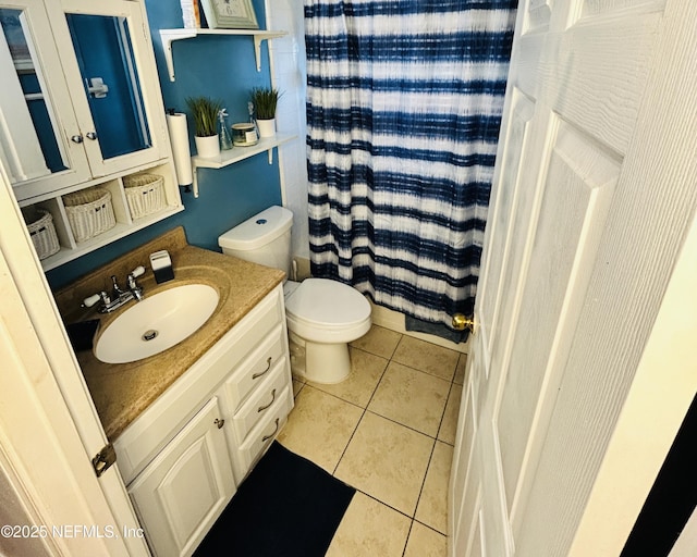 bathroom featuring vanity, a shower with curtain, tile patterned floors, and toilet