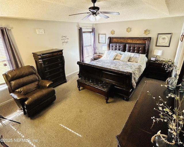 carpeted bedroom featuring ceiling fan and a textured ceiling