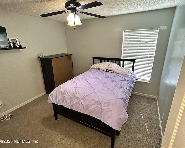 bedroom featuring carpet floors, ceiling fan, and a textured ceiling