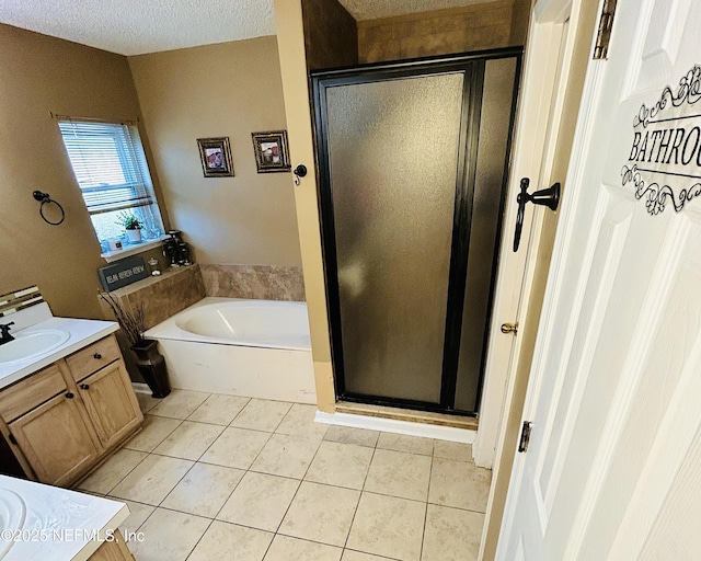 bathroom with tile patterned flooring, vanity, a textured ceiling, and shower with separate bathtub