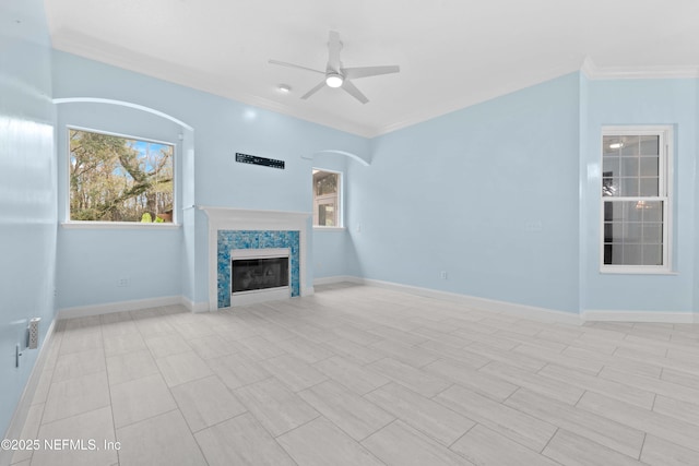 unfurnished living room featuring ceiling fan and crown molding