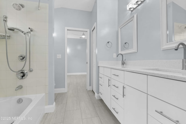 bathroom featuring vanity and tiled shower / bath