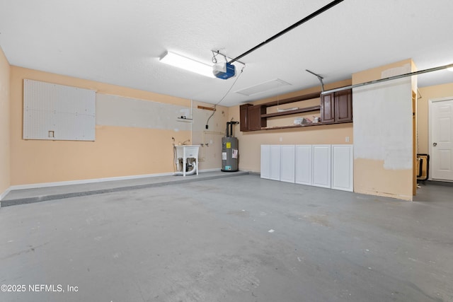 garage featuring a garage door opener, electric water heater, and sink