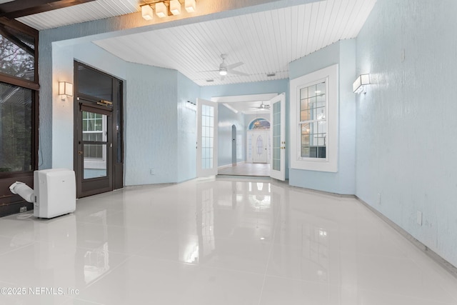 hallway with tile patterned flooring and french doors