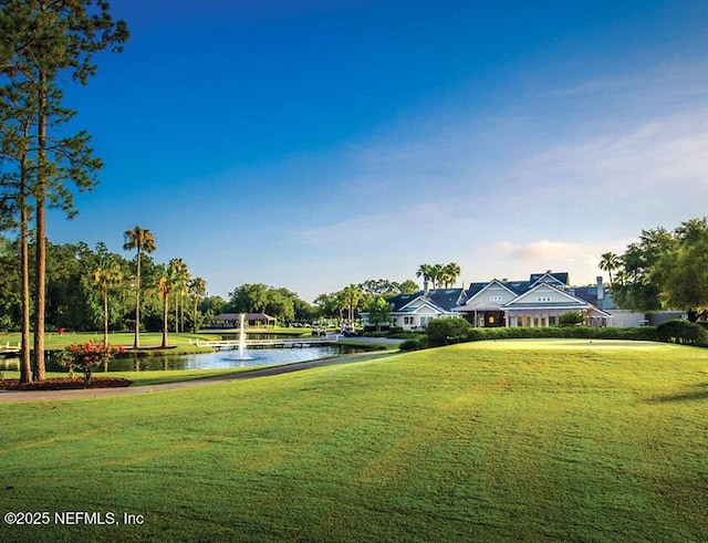 surrounding community featuring a yard and a water view