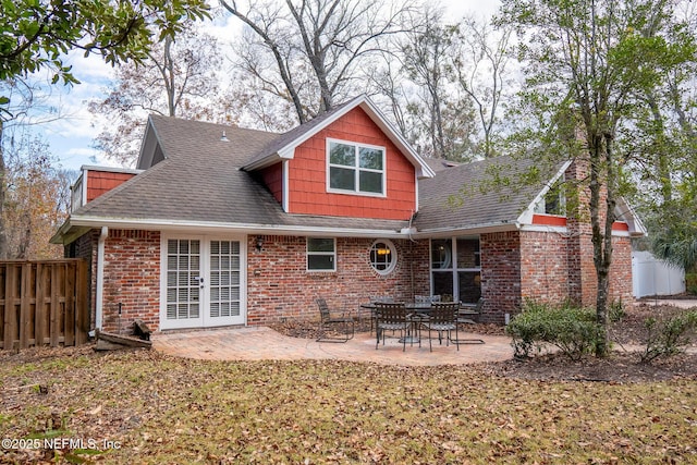 back of property with a yard, french doors, and a patio