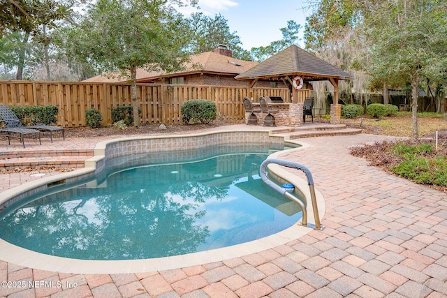 view of swimming pool featuring a gazebo, a bar, and a patio