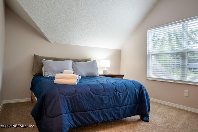 bedroom featuring a textured ceiling, lofted ceiling, and carpet floors