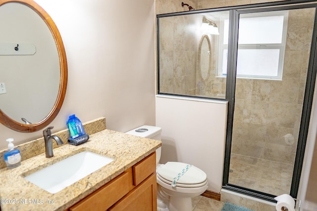 bathroom with toilet, vanity, tile patterned floors, and a shower with shower door