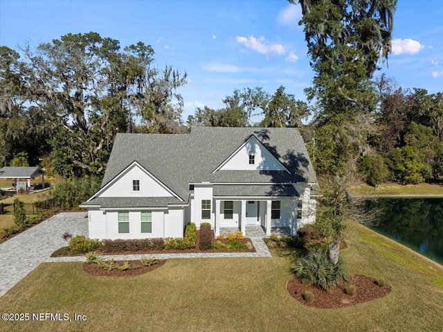 view of front facade featuring a front yard and a water view