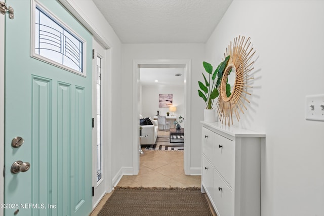 tiled foyer entrance with a textured ceiling