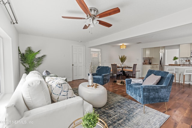 living room with ceiling fan and dark hardwood / wood-style floors