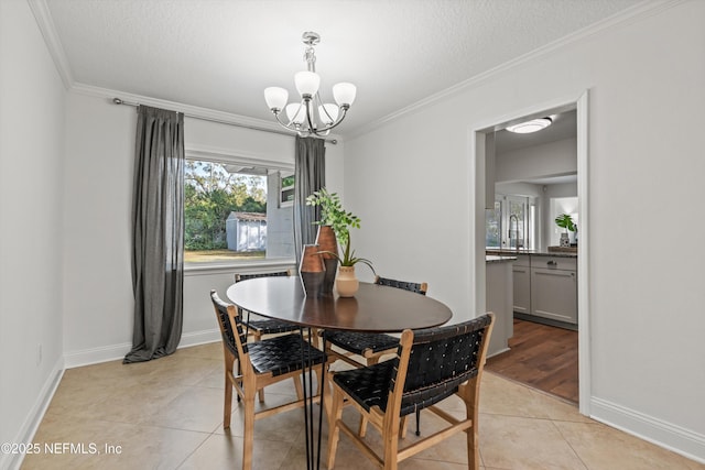 dining space with crown molding, an inviting chandelier, a textured ceiling, and light tile patterned floors