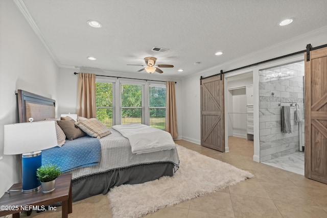 bedroom featuring ornamental molding, a barn door, ceiling fan, and a textured ceiling