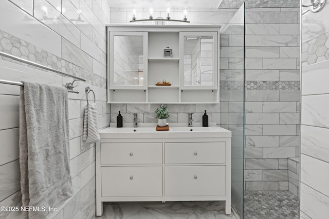 bathroom featuring vanity, tile walls, and a tile shower