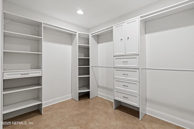 walk in closet featuring light tile patterned flooring