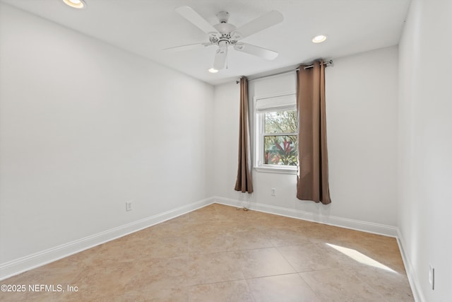 empty room with light tile patterned floors and ceiling fan