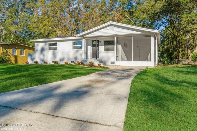 view of front of house with a front yard and a carport