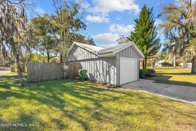 view of side of home with a lawn and a garage