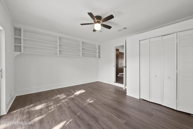 unfurnished bedroom featuring a closet, ceiling fan, ornamental molding, and dark hardwood / wood-style floors