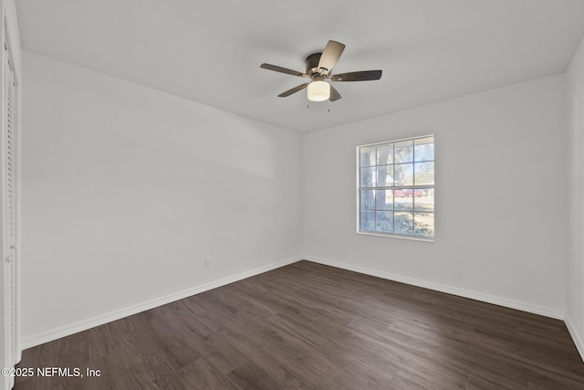 empty room featuring ceiling fan and dark hardwood / wood-style floors