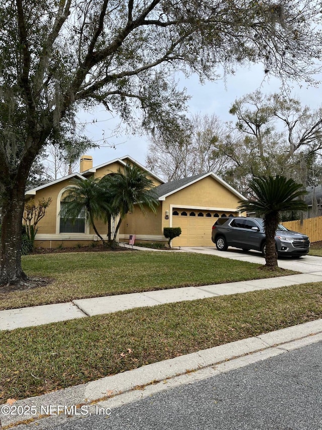 single story home featuring a front yard and a garage