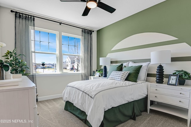 bedroom with light colored carpet, ceiling fan, and baseboards