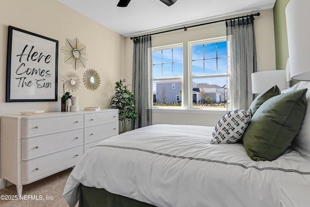 bedroom featuring dark colored carpet and a ceiling fan