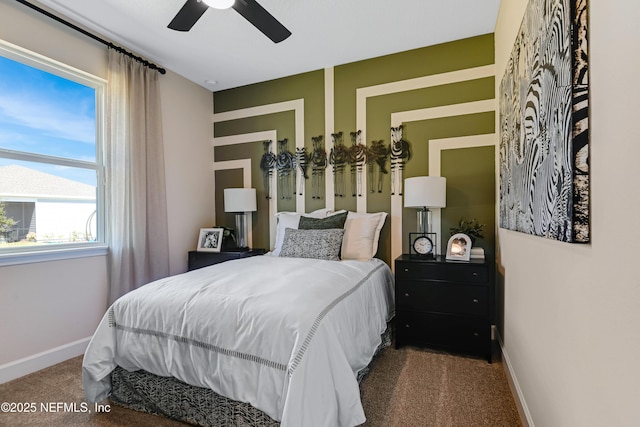 carpeted bedroom with ceiling fan and baseboards