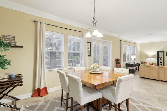 dining room with crown molding and light tile patterned floors