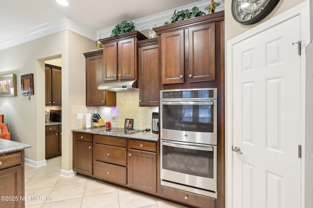 kitchen with tasteful backsplash, ornamental molding, stainless steel double oven, black electric stovetop, and light stone countertops