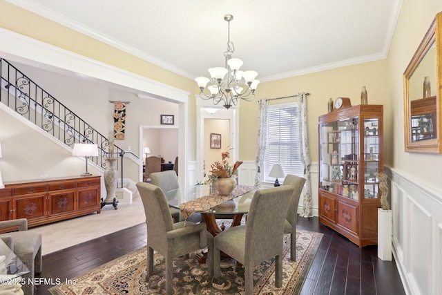 dining space with ornamental molding, dark wood-type flooring, and a chandelier