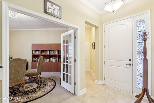 foyer entrance with crown molding, french doors, a textured ceiling, and light tile patterned flooring