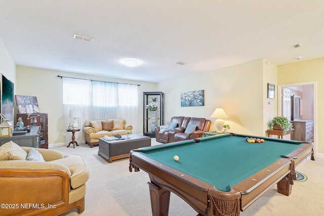 playroom featuring light carpet, pool table, and a textured ceiling