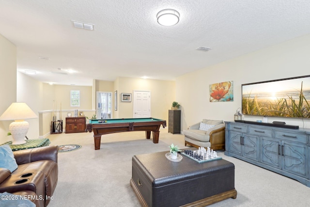 rec room featuring light carpet, a textured ceiling, and billiards