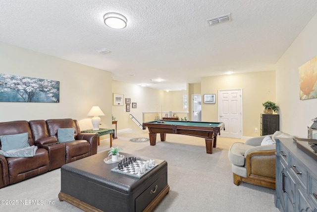 recreation room with light carpet, billiards, and a textured ceiling