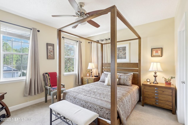 bedroom featuring light carpet and ceiling fan