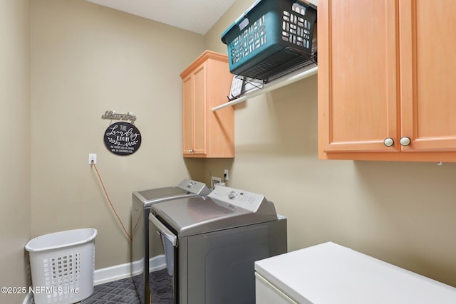 washroom featuring cabinets and washer and dryer