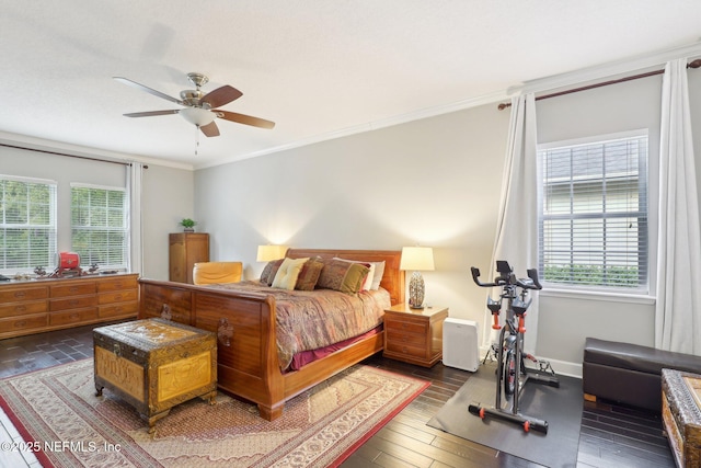 bedroom with ornamental molding, dark hardwood / wood-style floors, and ceiling fan