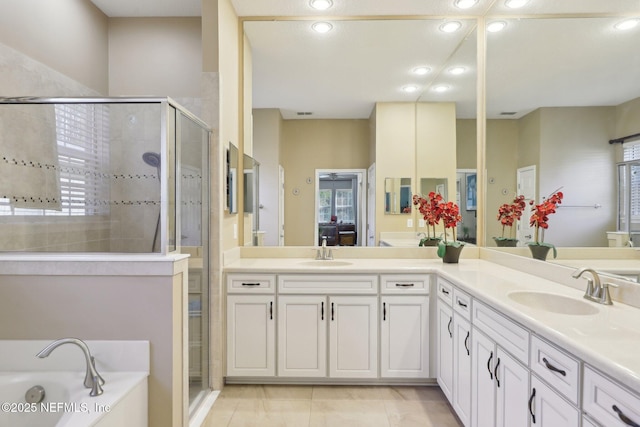 bathroom with vanity and separate shower and tub