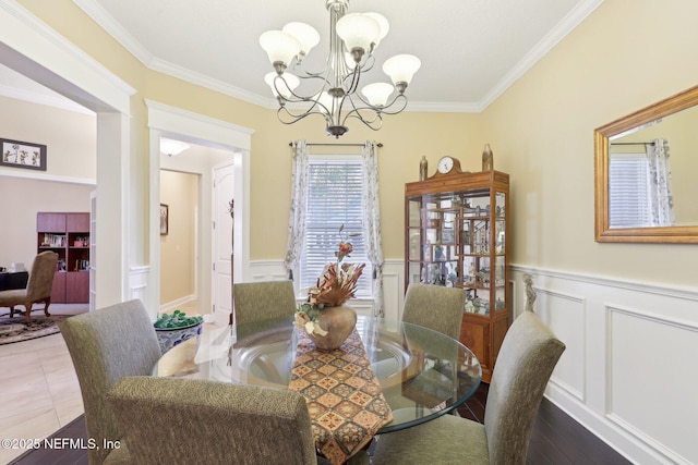 dining room with an inviting chandelier and ornamental molding