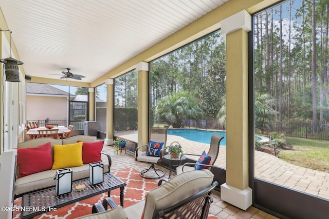 sunroom / solarium featuring ceiling fan