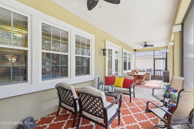 sunroom / solarium featuring ceiling fan