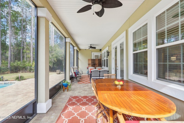 sunroom / solarium with ceiling fan